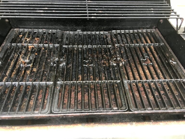 A dirty grill grate before a professional grill cleaning