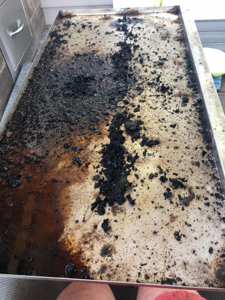 Very greasy and dirty grill pan prior to receiving our services