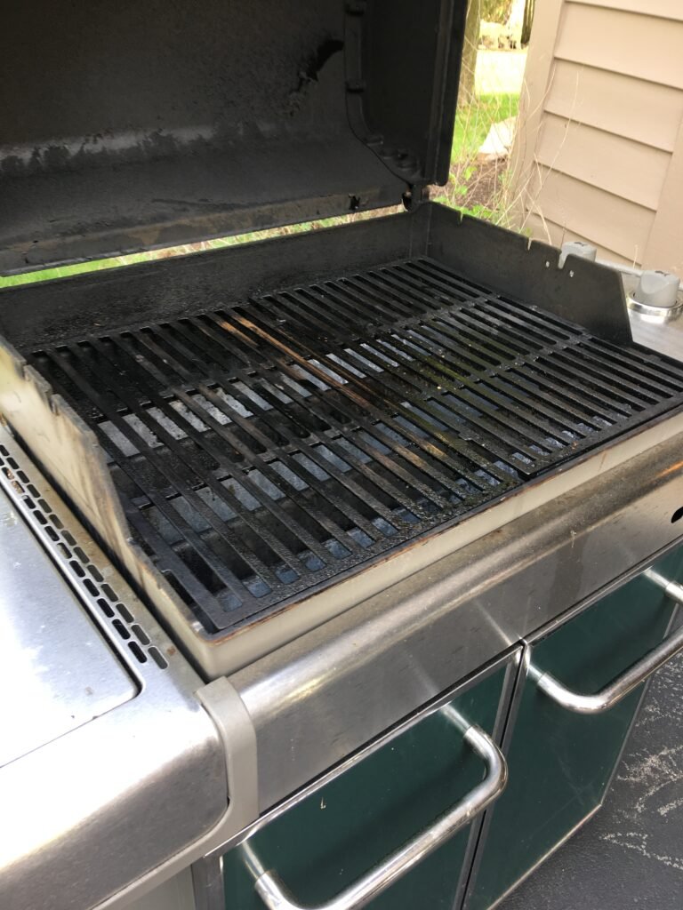 Closeup of dirty grate on green grill prior to professional grill cleaning